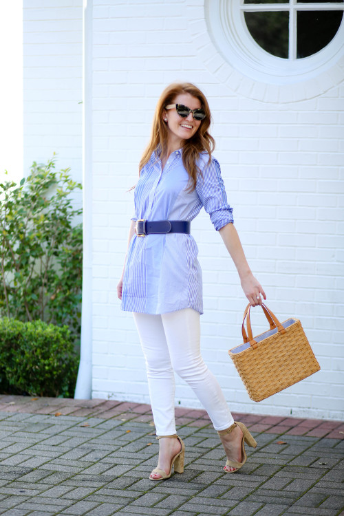 Design Darling's Mackenzie Horan in a J.McLaughlin tunic, navy leather belt, white skinny jeans, straw tote bag, and Steve Madden Carrson sandals.