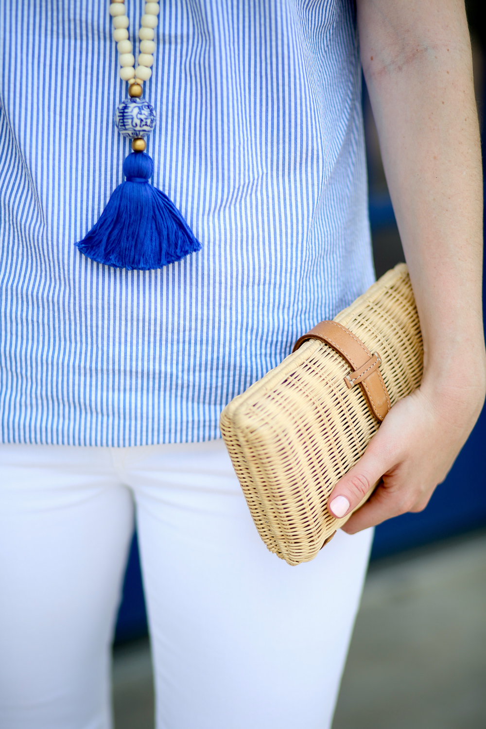 Design Darling Cricket blue tassel necklace, Tuckernuck seersucker top, and J.Crew rattan clutch