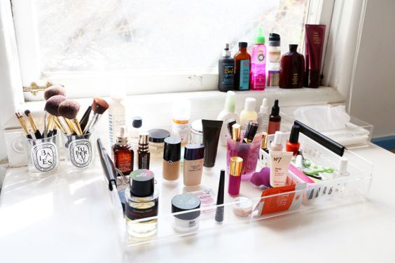 makeup organization with lucite tray and old candles