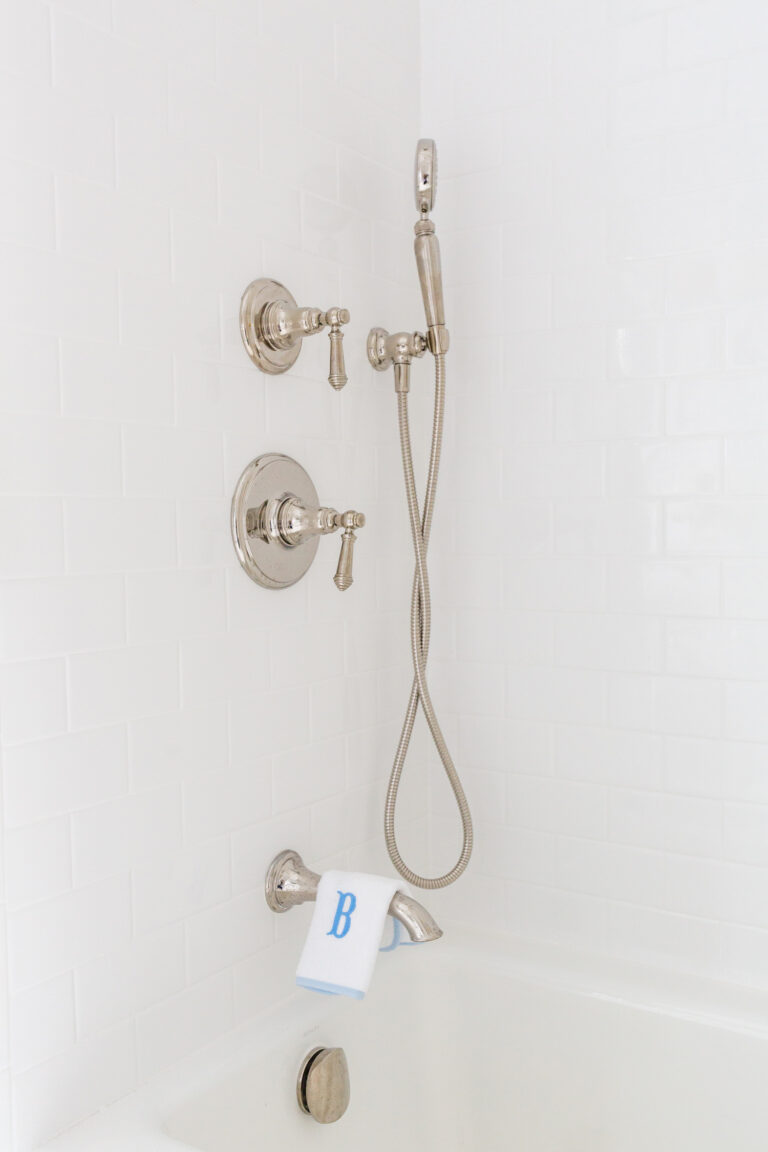 kohler artifacts shower system in polished nickel with white subway tile
