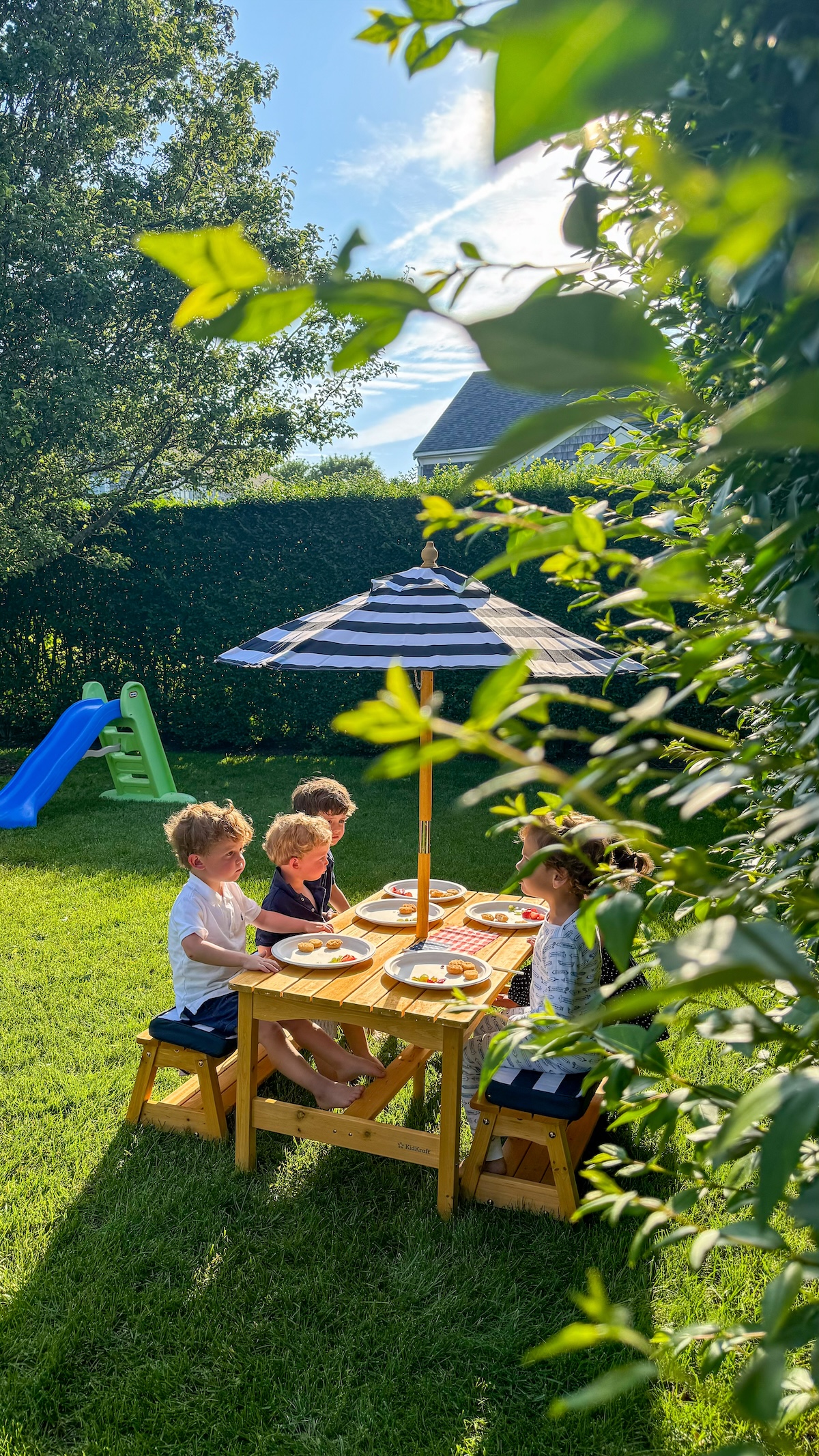 kids' picnic table with striped umbrella