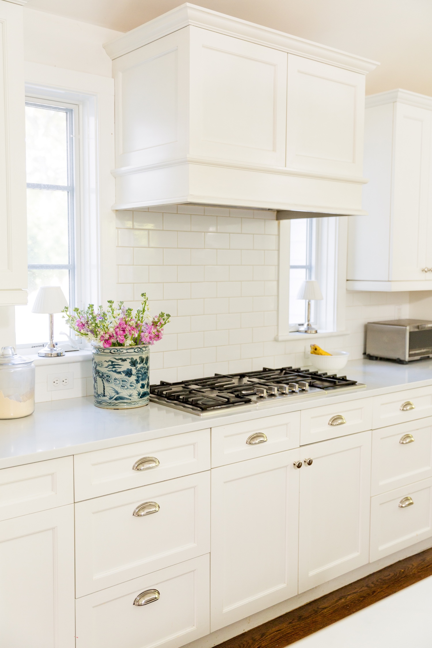 Pottery Barn x Brandon Maxwell Camille wireless touch table lamps on kitchen windows beside stove hood