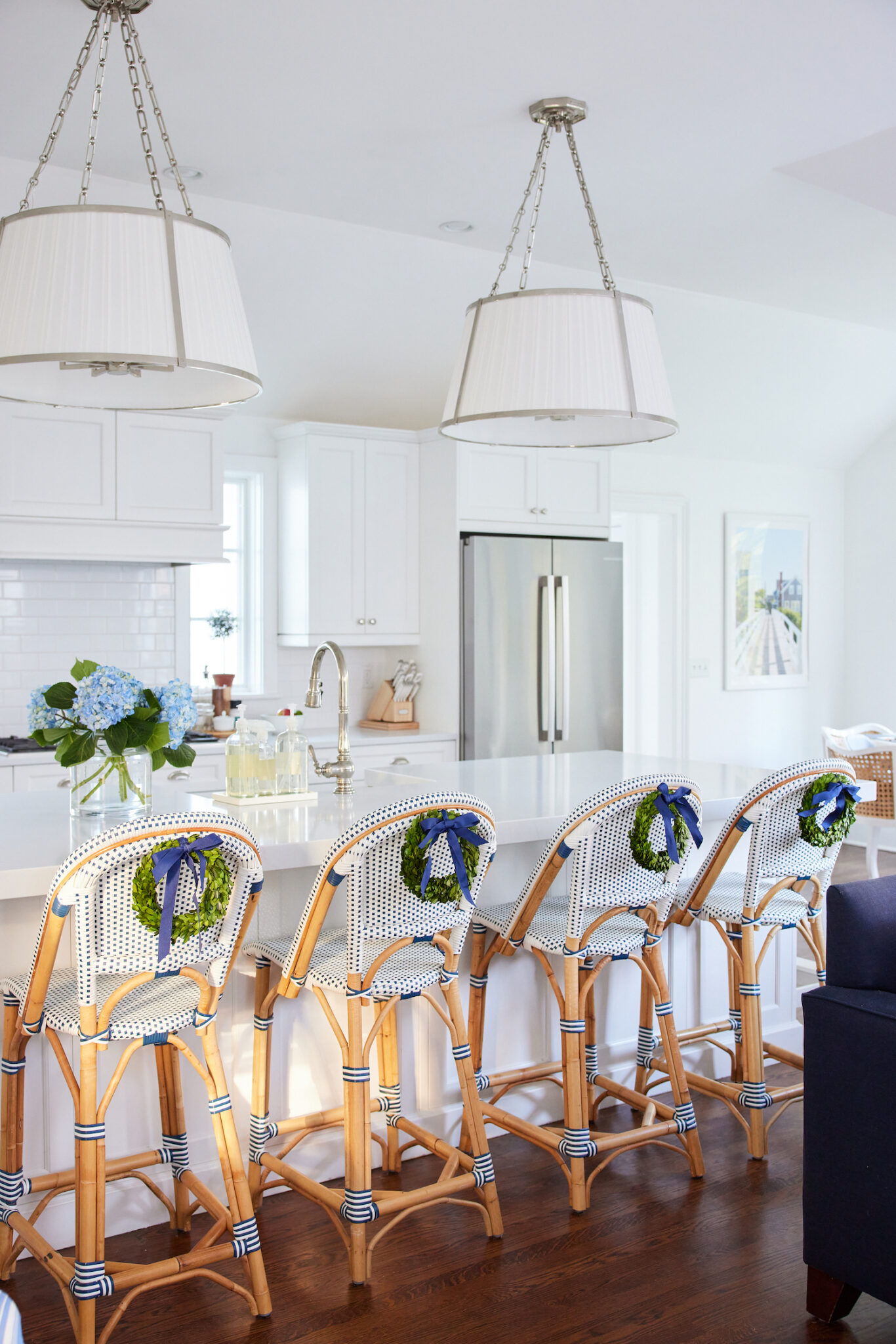 mini boxwood wreaths on kitchen counter stools